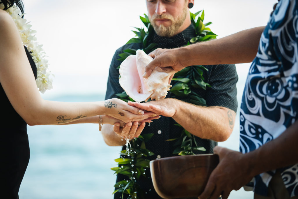 Bride and groom getting married on the beach.
