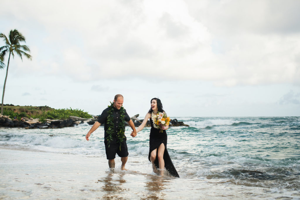 Bride and groom in the ocean.