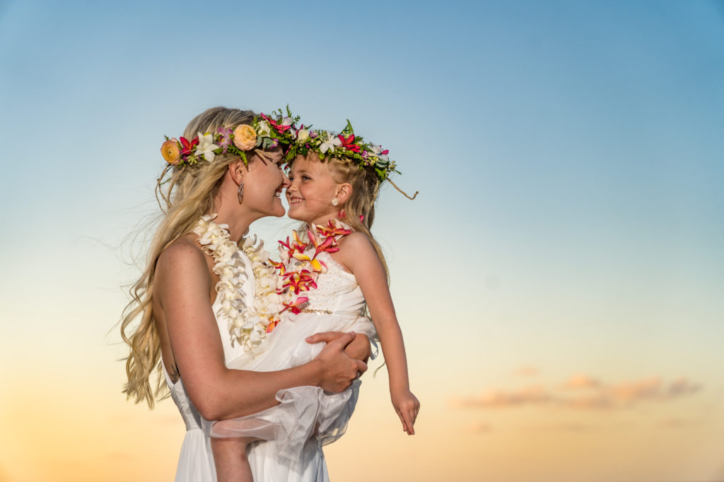 Bride and daughter at sunset on the beach.