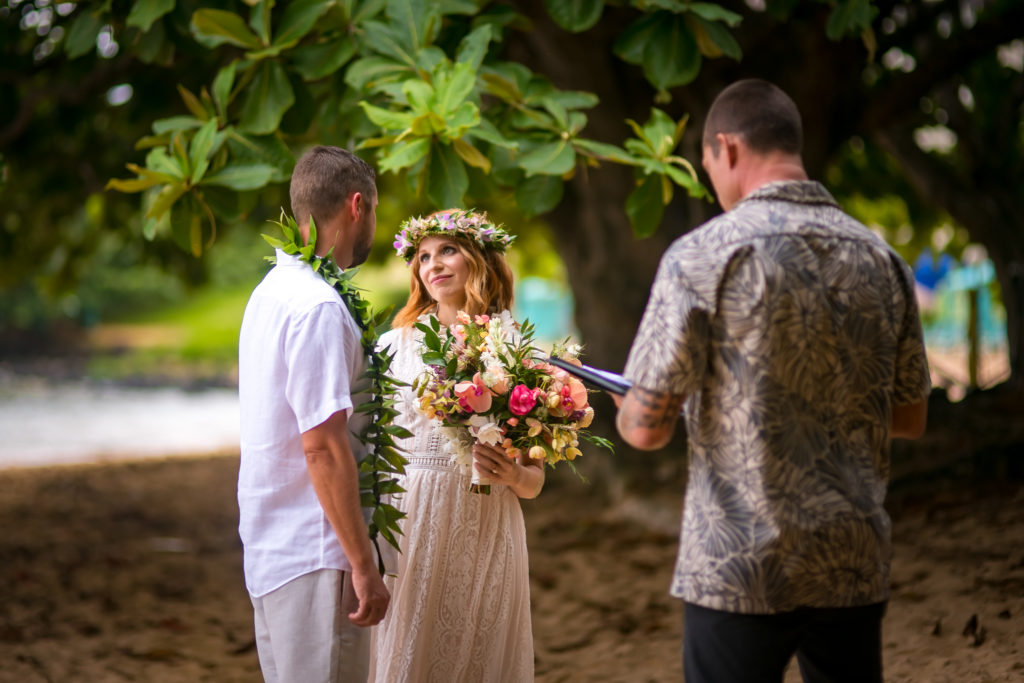 Bride and groom get married on the beach.