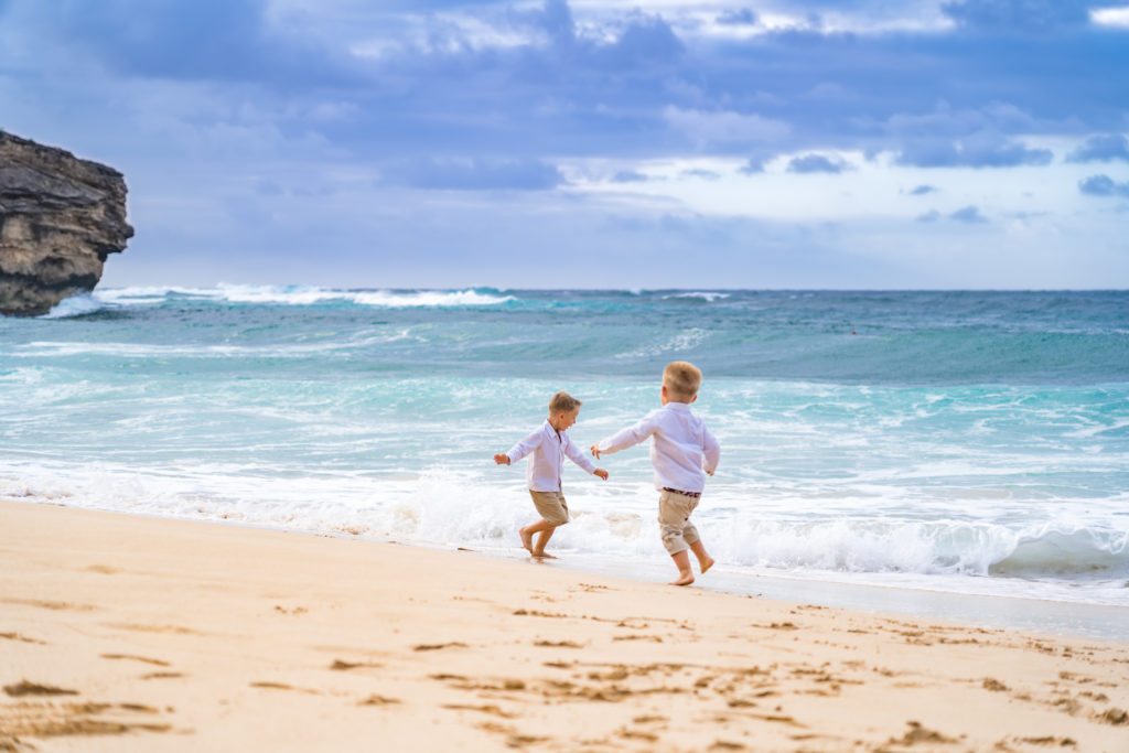 Young kids playing in the ocean.