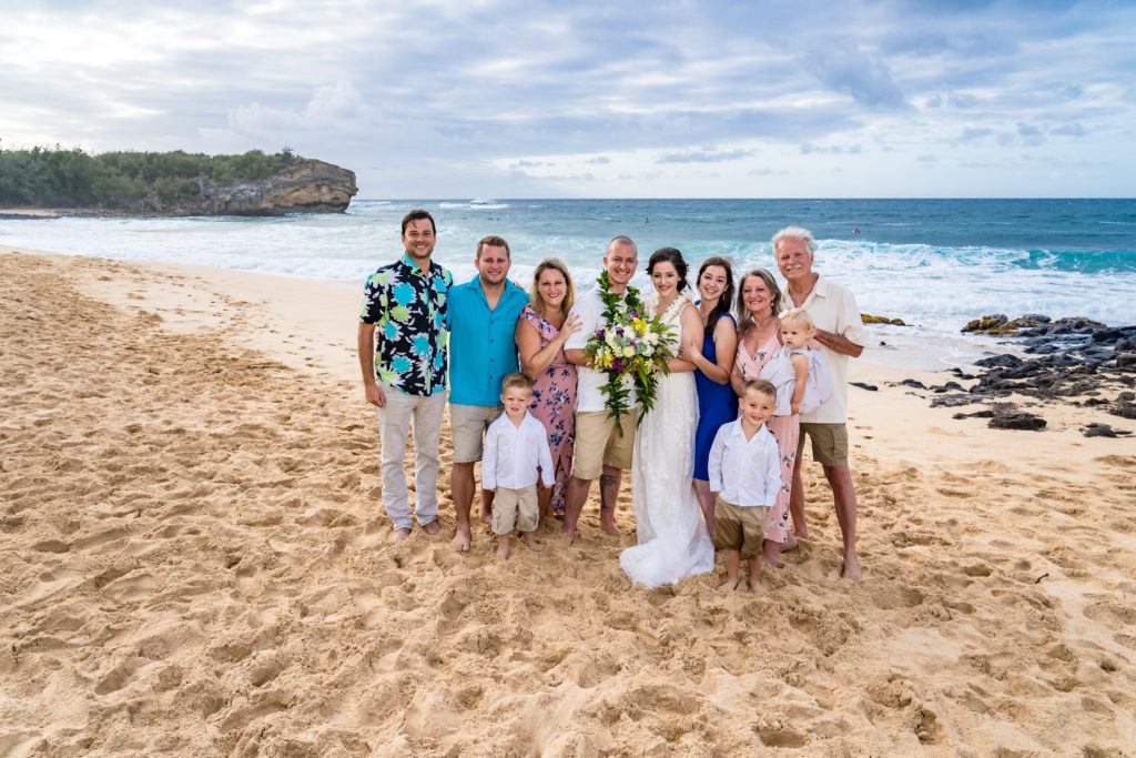 Bride, groom and family posing for photo.