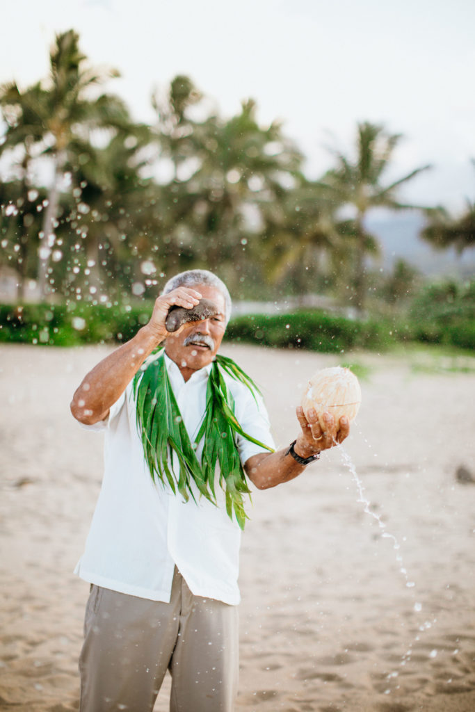Opening coconut on the beach.