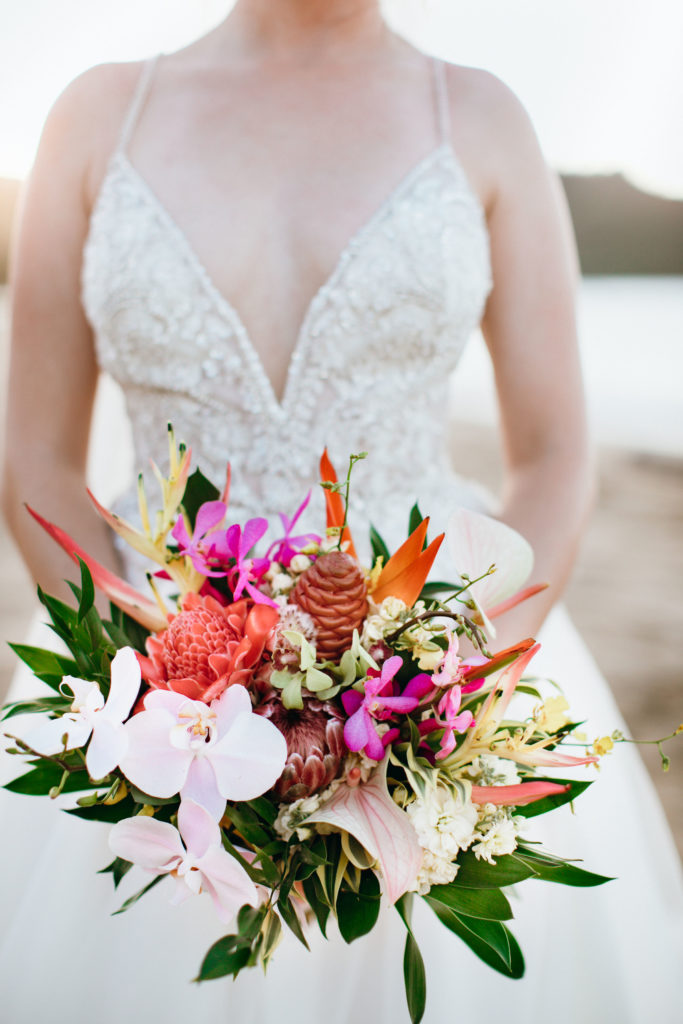Bride holding flower bouquet.