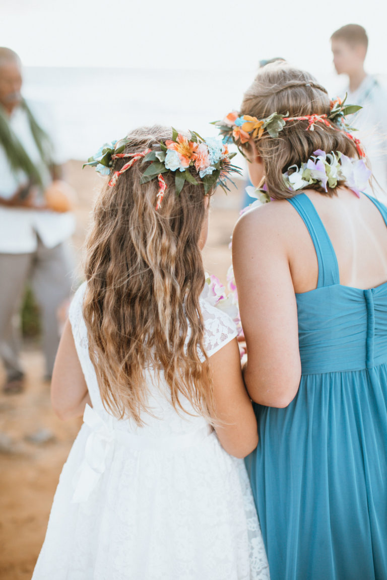 Young girls with leis and flowers.