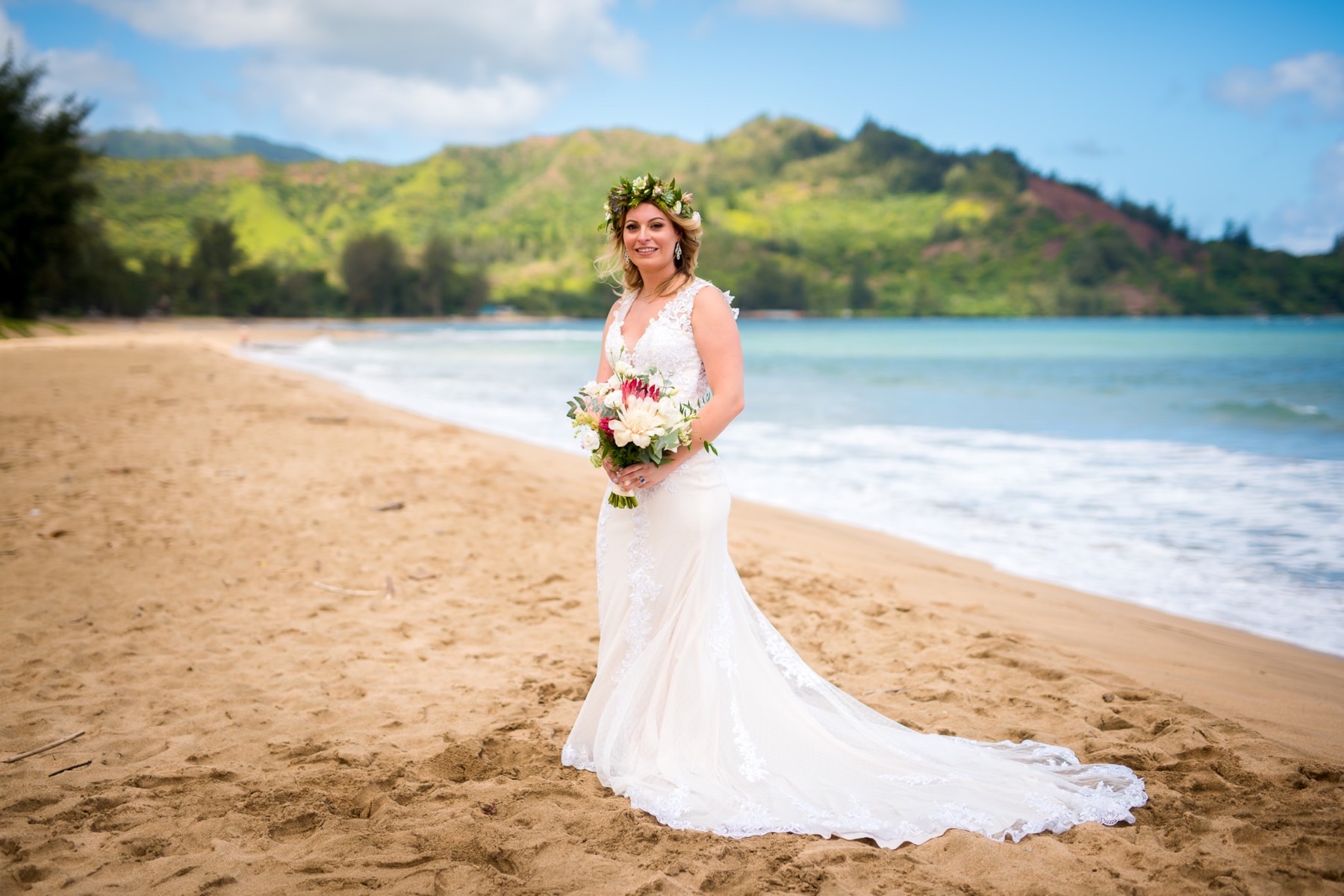 Bride with flowers on the beach.