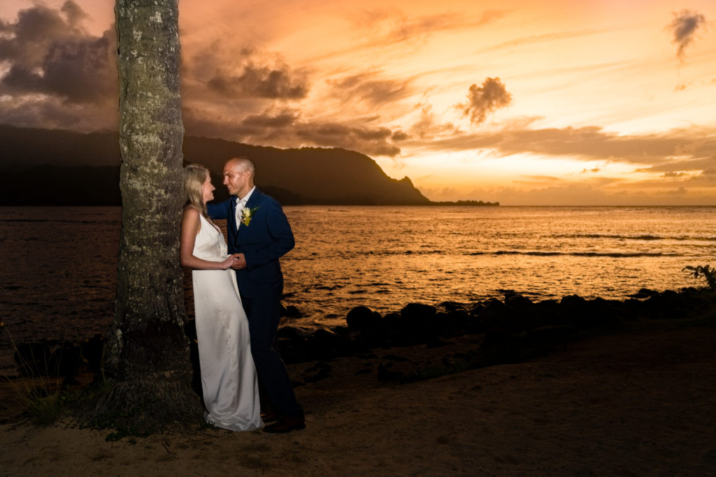 Bride on groom posing at sunset.