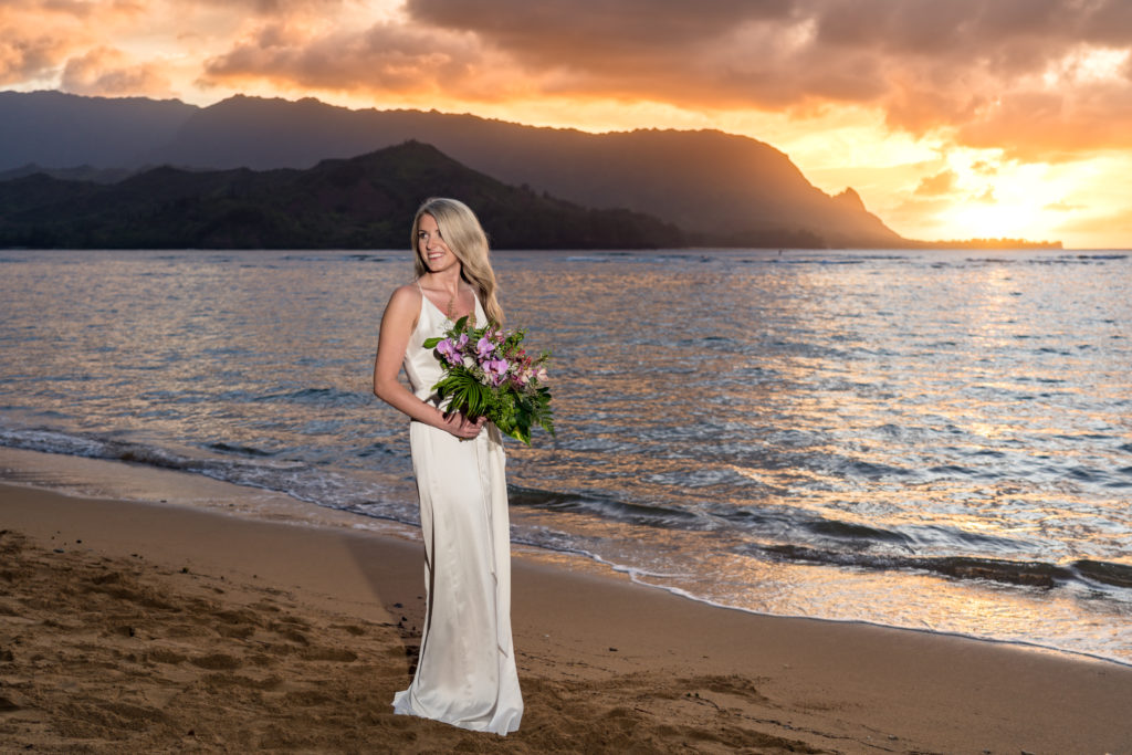 Bride on the beach at sunset.