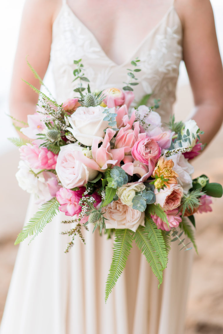 Bride holding Hawaiian flower bouquet.