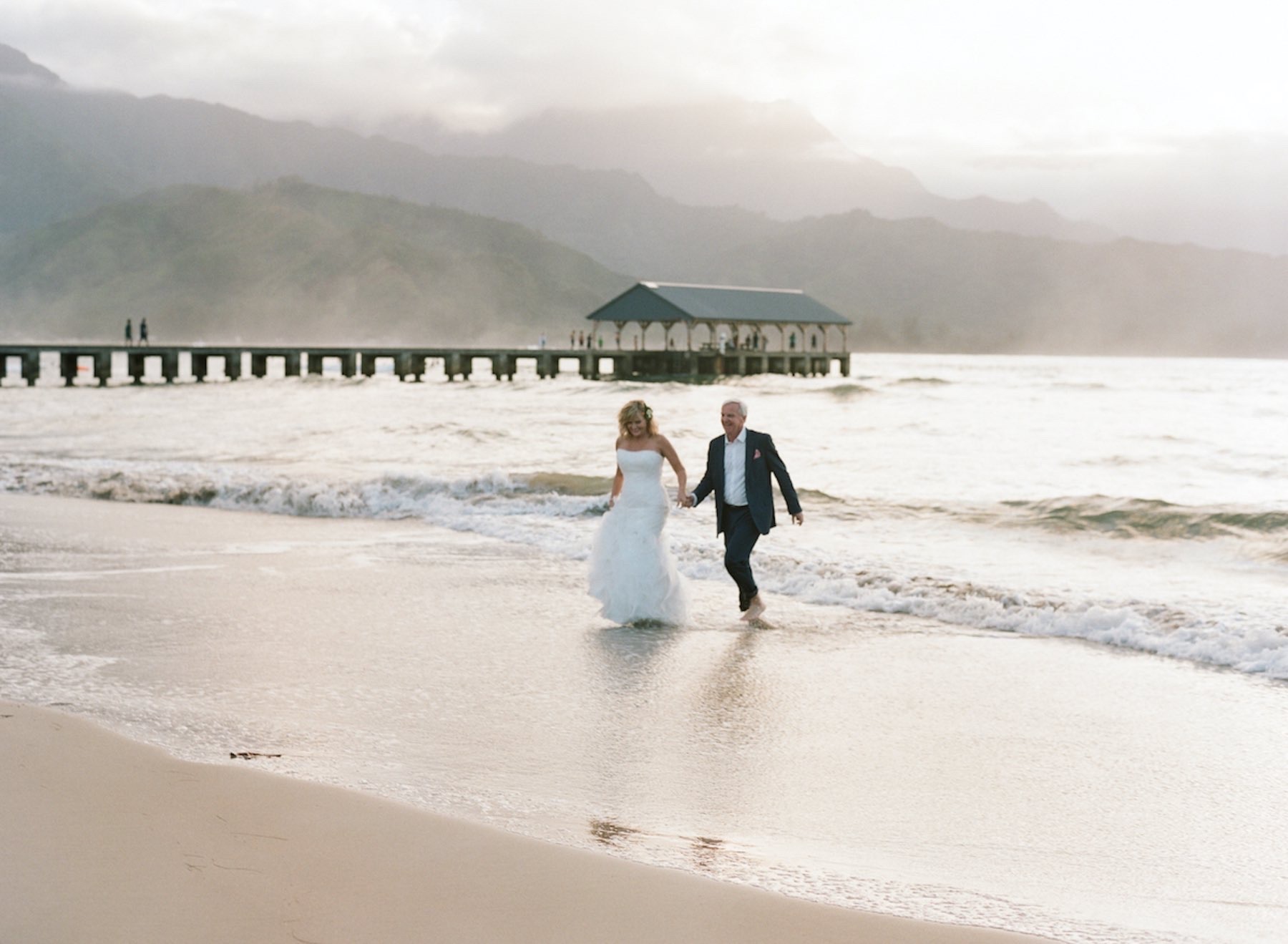 Jim & Rebecca walking on the beach in Kauai.