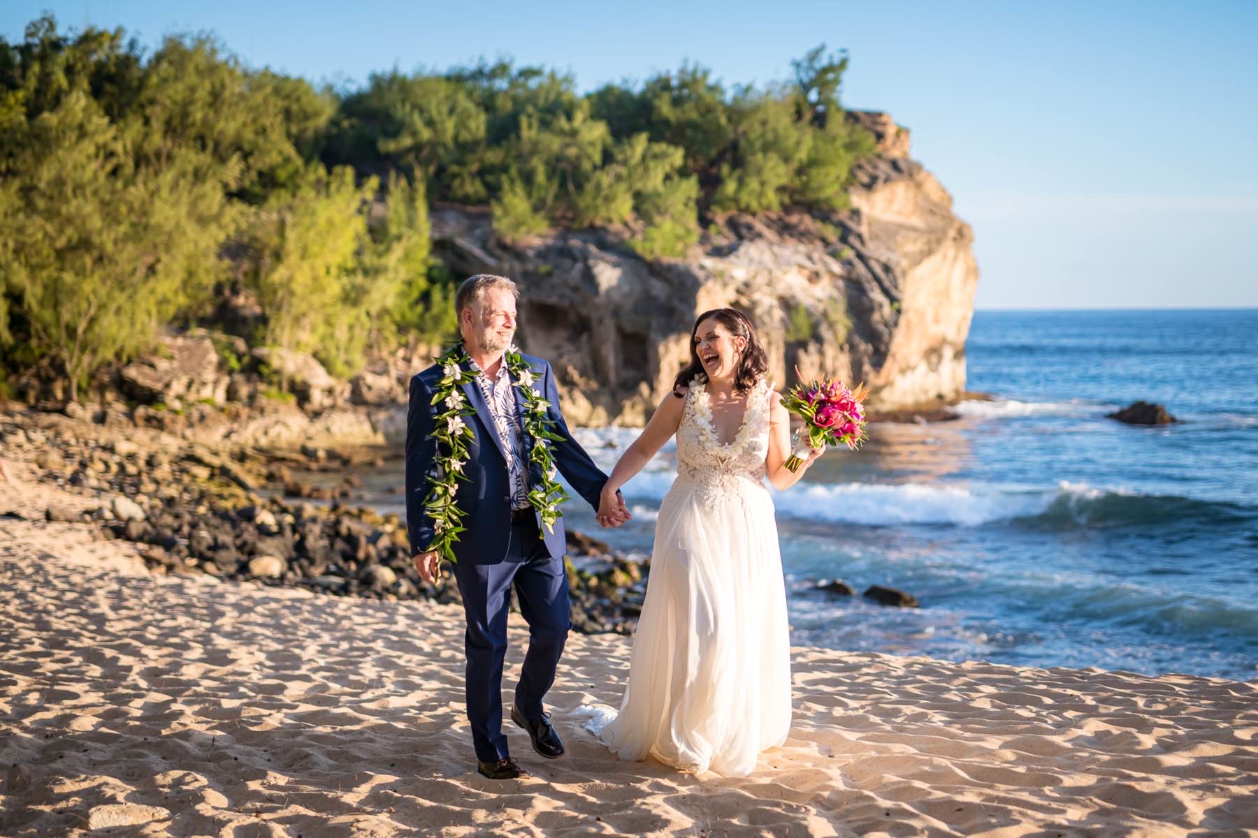 Corina & Kipp walking on the beach in Kauai.
