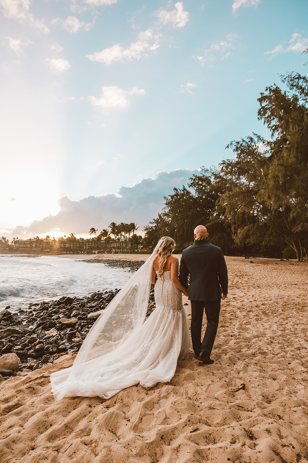 Stunning Kauai Elopement at Shipwrecks beach in September. Maddie and Seth has Kahu Ai as their officiant and Annie Hart as their photographer. 