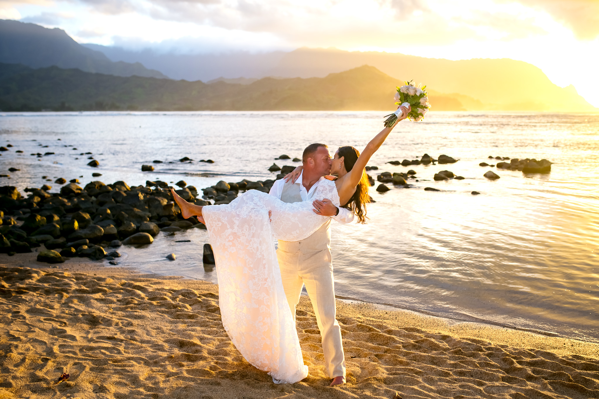 Intimate sunset ceremony at Puu Poa beach below One Hotel Hanalei in April for Ashley and Kristy