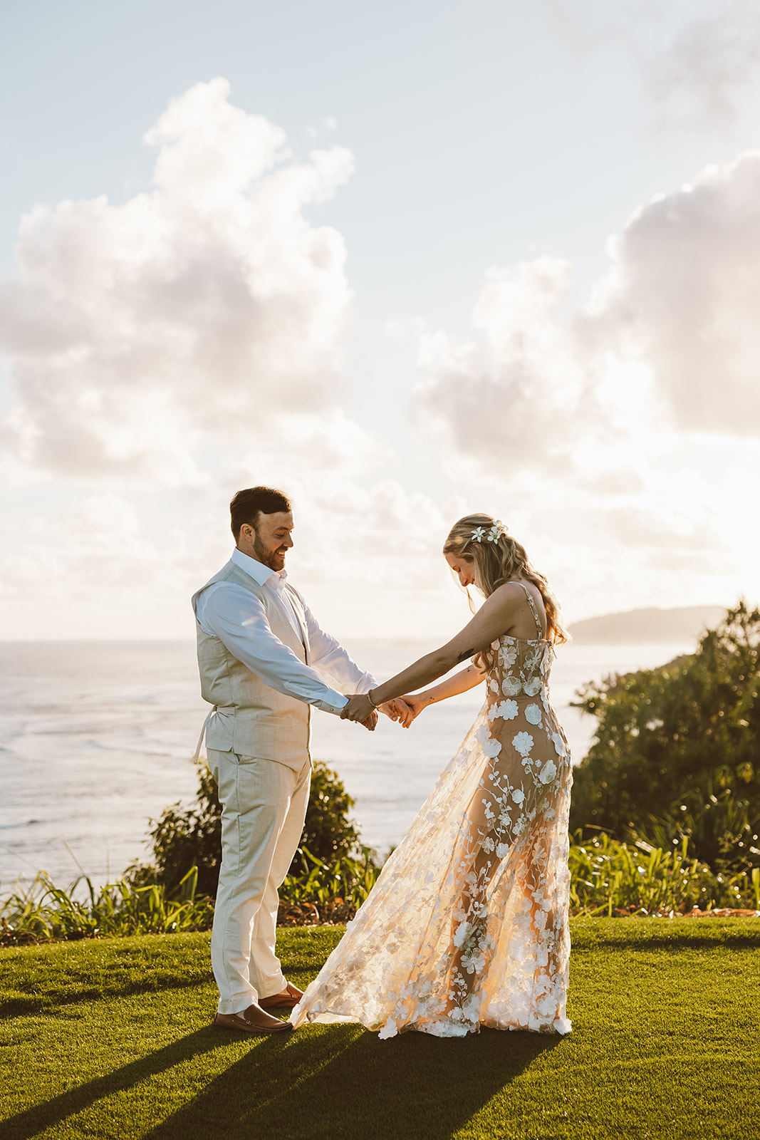 couple standing under palm trees on the beach