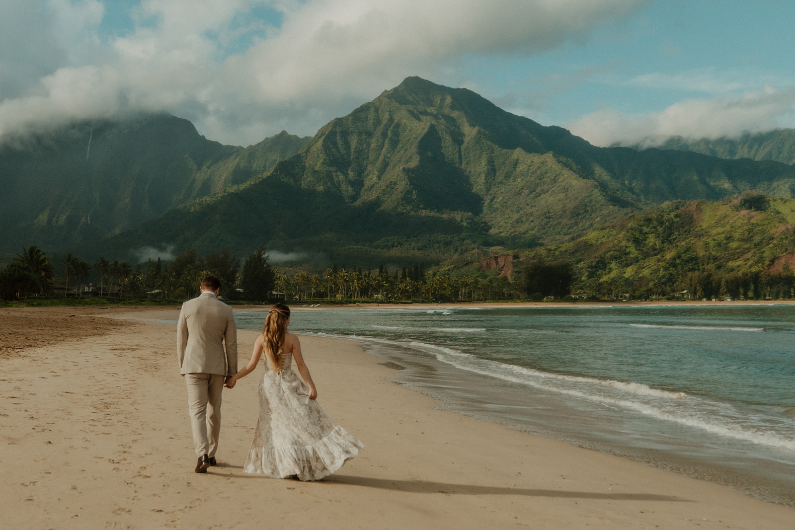Couple on the beach in Hanalei Bay.