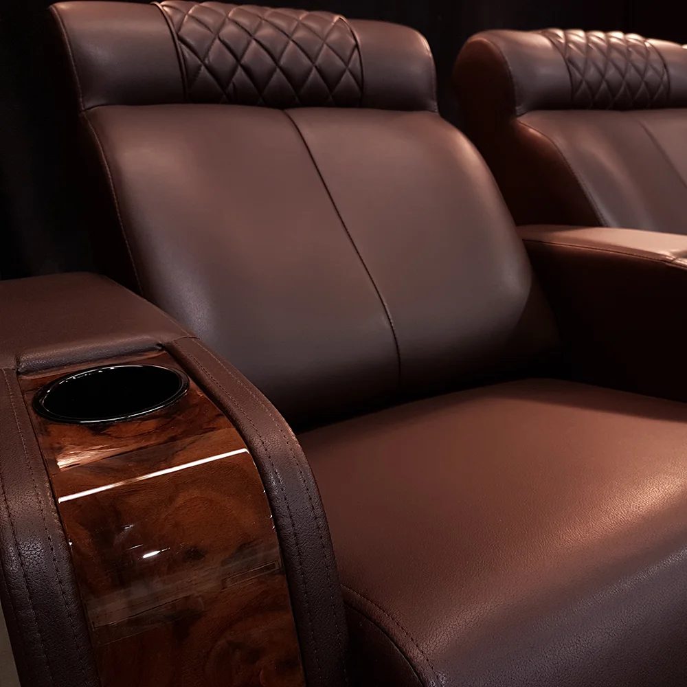 Luxury home theater recliner detail featuring premium leather upholstery and high-gloss wood trim armrest by Elite HTS