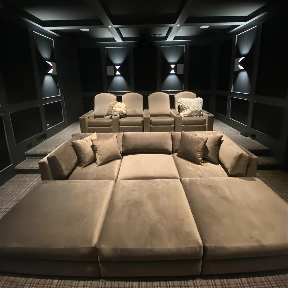 Front row sectional seating with rear recliners in a custom home theater