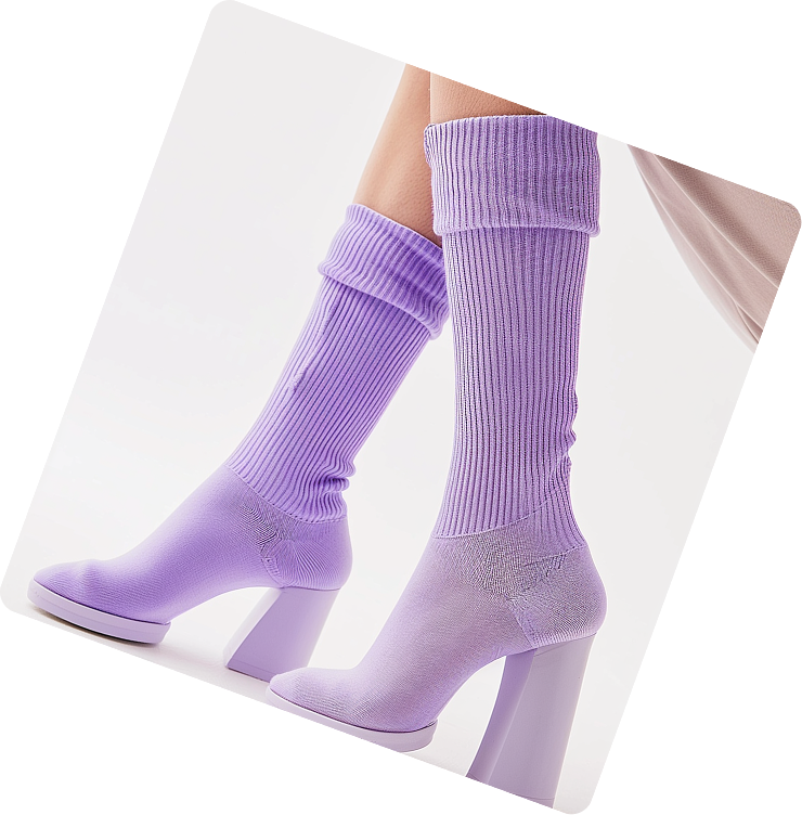 Pair of legs wearing pastel purple heeled sock boots with ribbed upper and thick block heels.