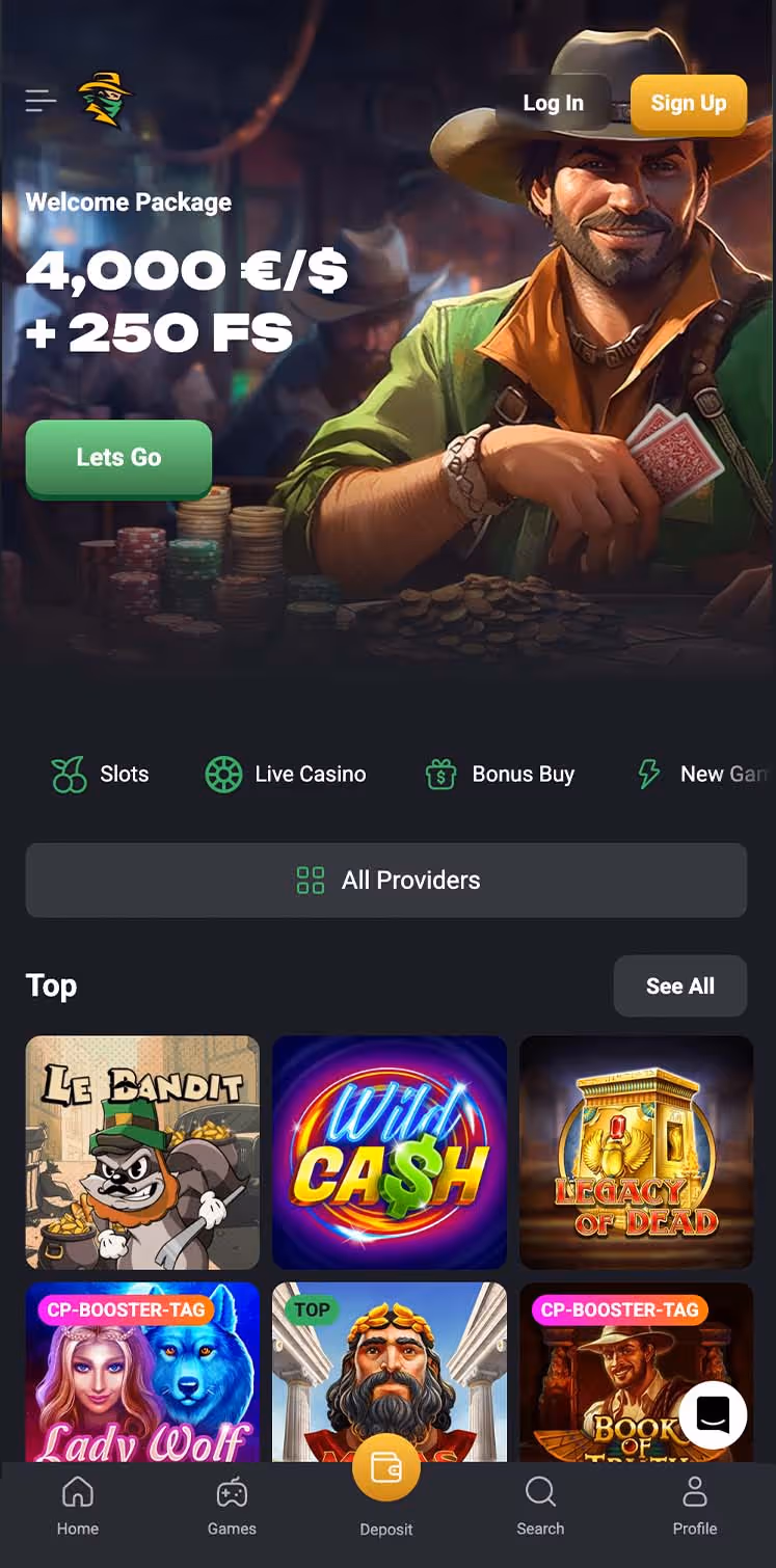 smiling hunter wearing a cowboy hat and a green shirt with sleeves rolled up sitting at a table with stacks of chips