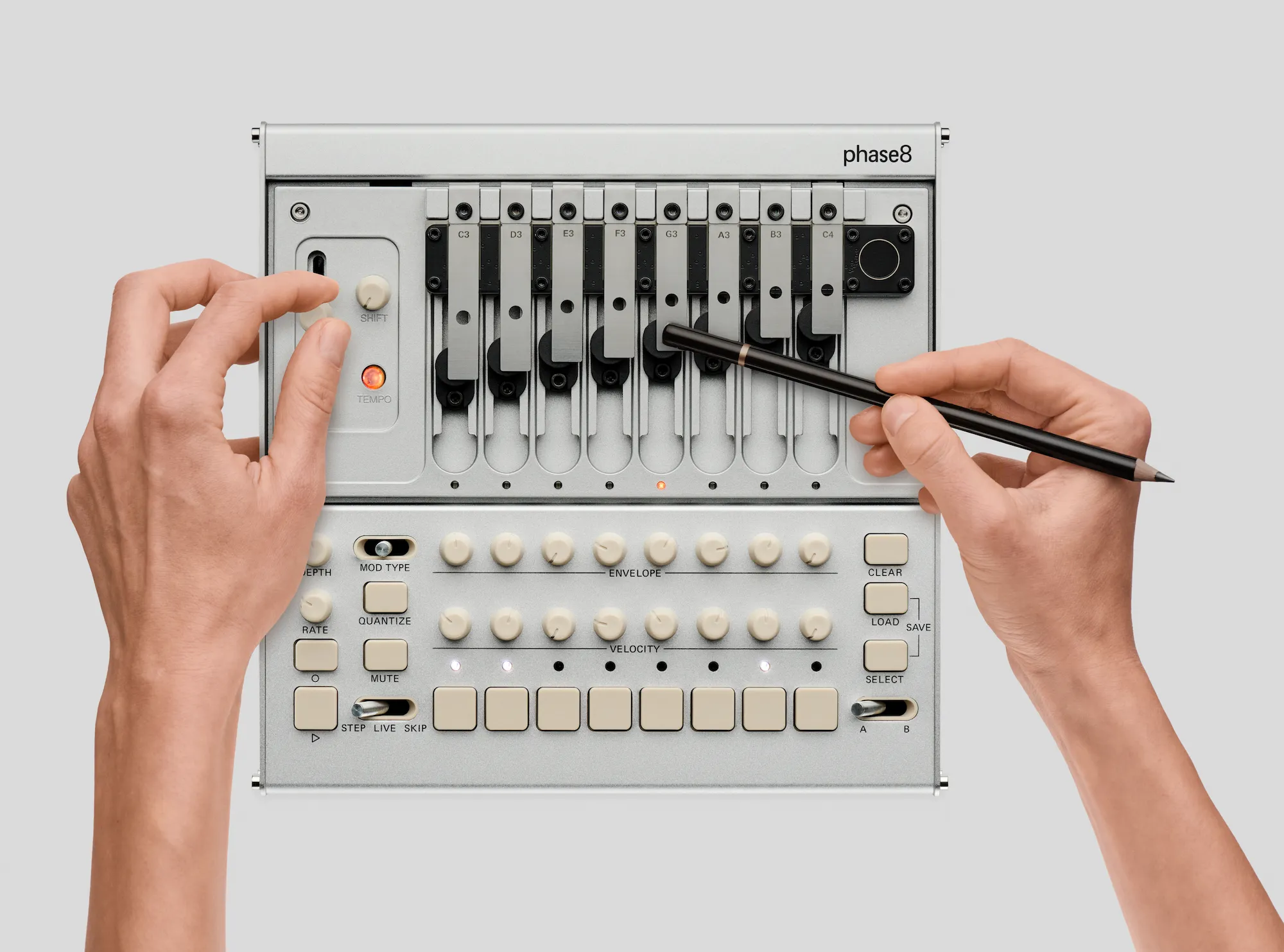 Hands crafting sounds with the KORG phase8.