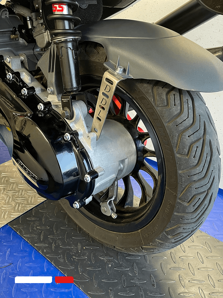 achterwiel van scooter met band en aandrijving tijdens onderhoud bij scootzuid in sittard-geleen
