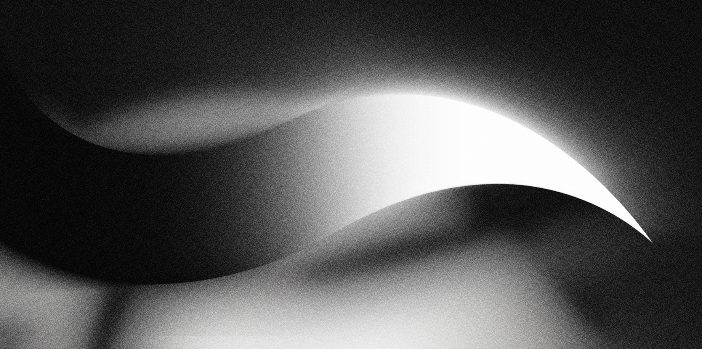 Abstract black and white image featuring smooth, curved gradient shapes with a bright curved highlight.