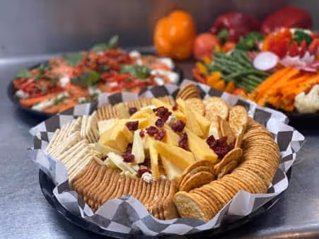 A bunch of trays with a variety of food ready to be served.