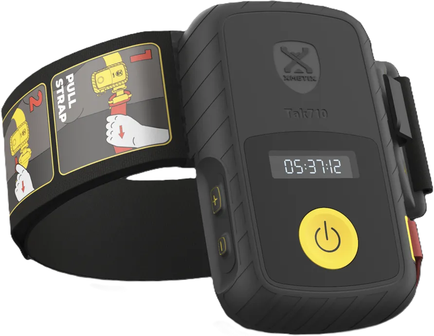 Black and yellow XMETRX Tak710 time-tracking device with digital screen and adjustable strap showing instructions.