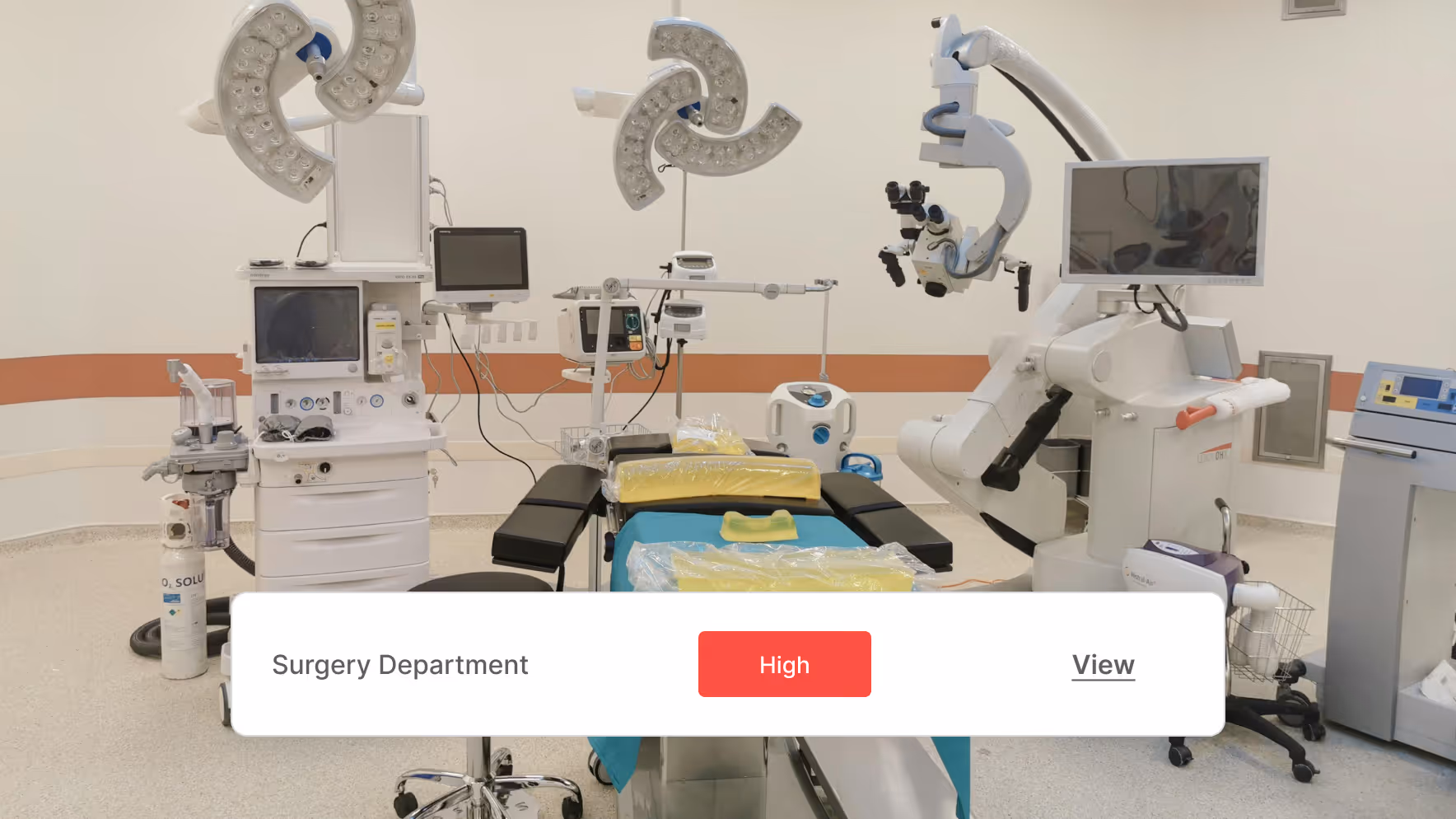 Modern surgery room with an operating table, surgical lights, monitors, and medical equipment.