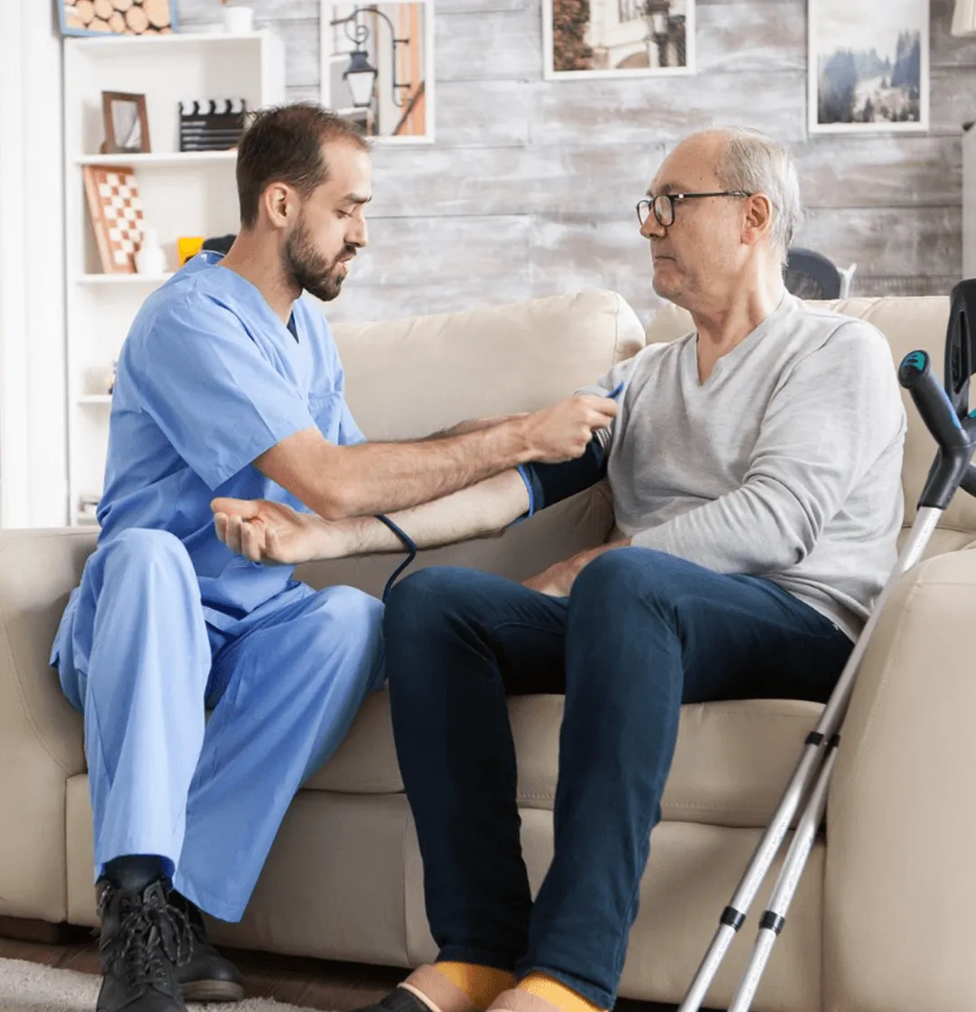 A man sitting on top of a couch next to another man.