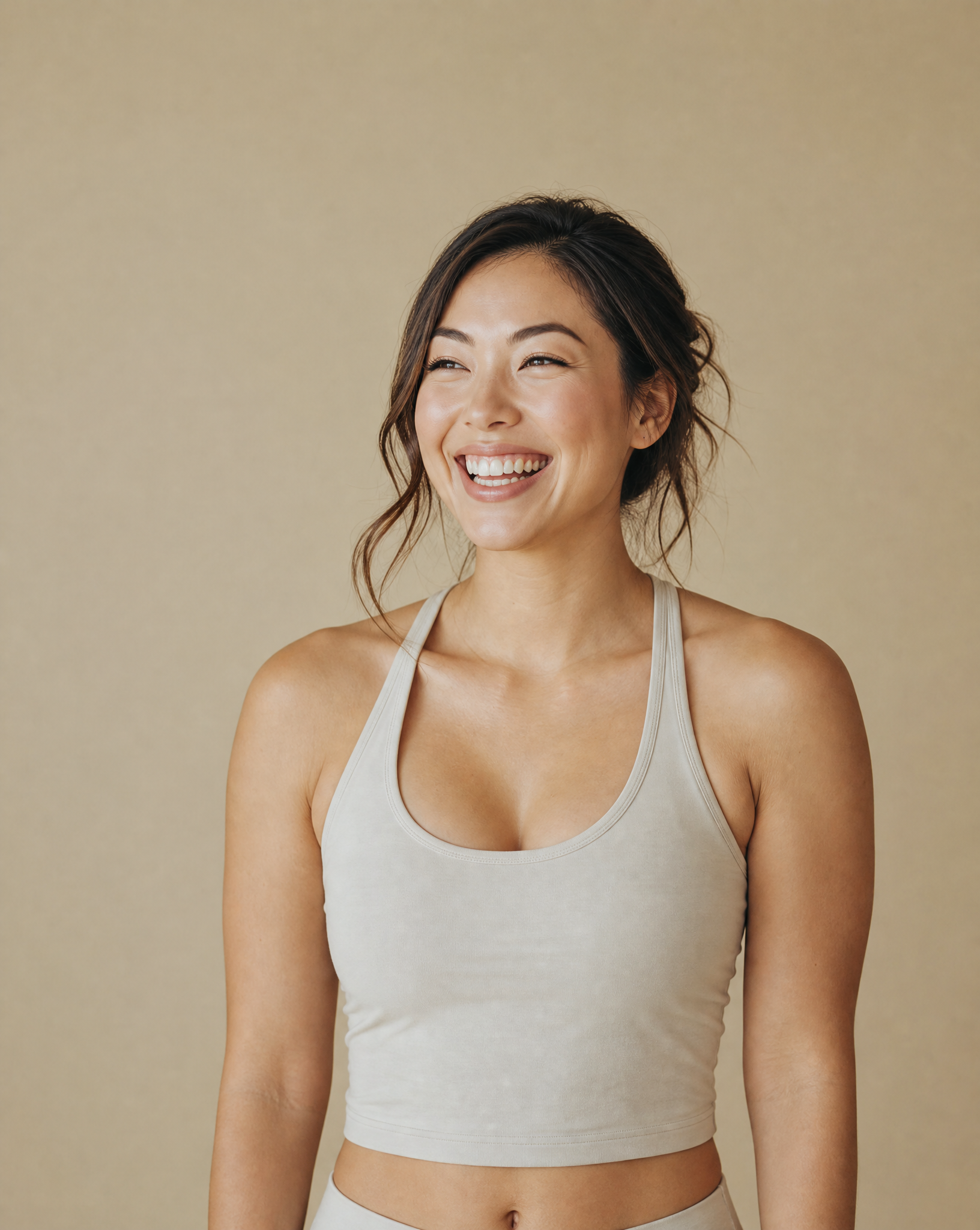 Smiling woman in cream athletic top
