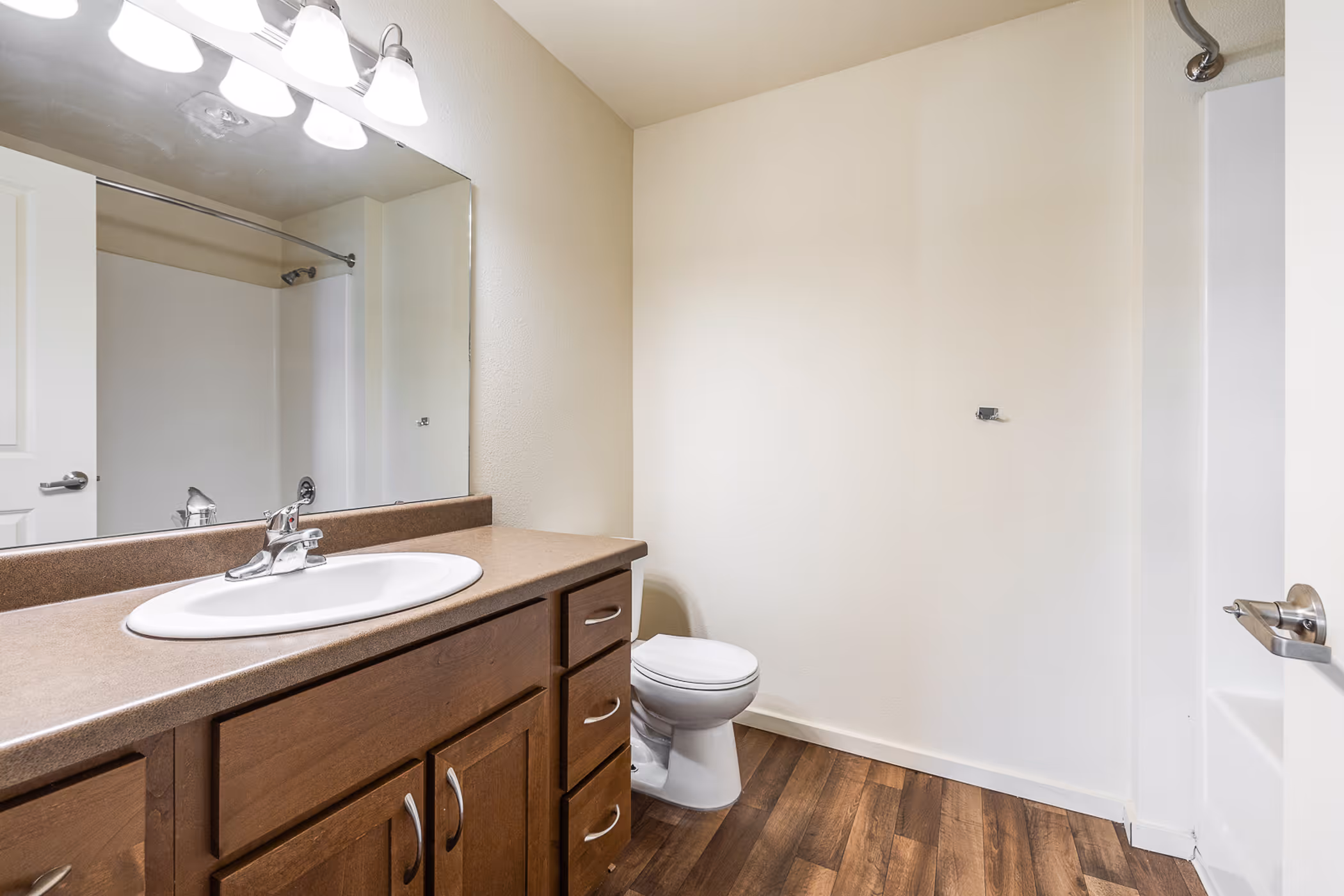 Empty bathroom with brown cabinets