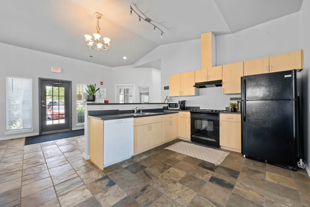 community kitchen with black appliances