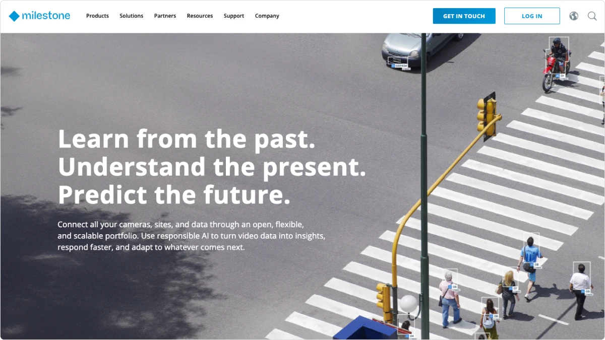 A street with people walking across a crosswalk.