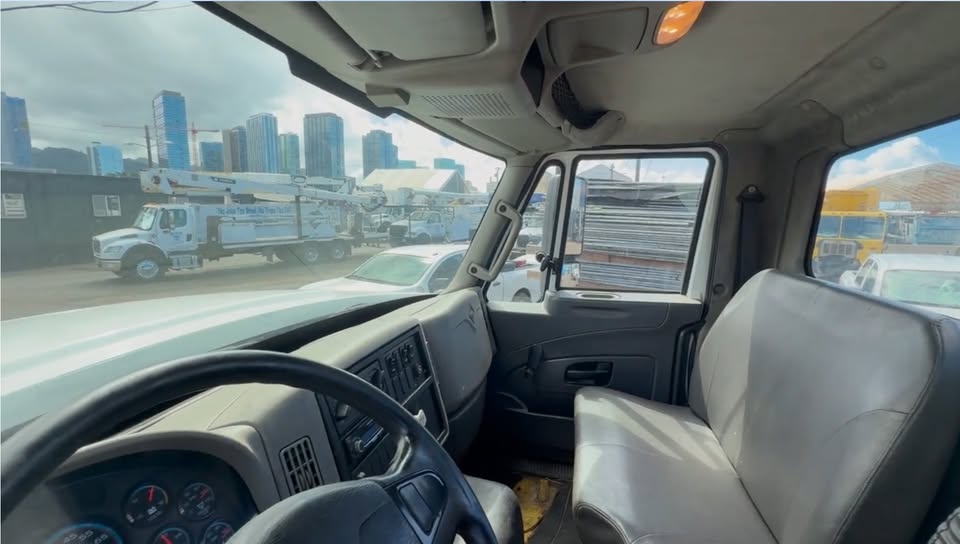 Cab interior of the 2011 International with grey vinyl bench seat and dash