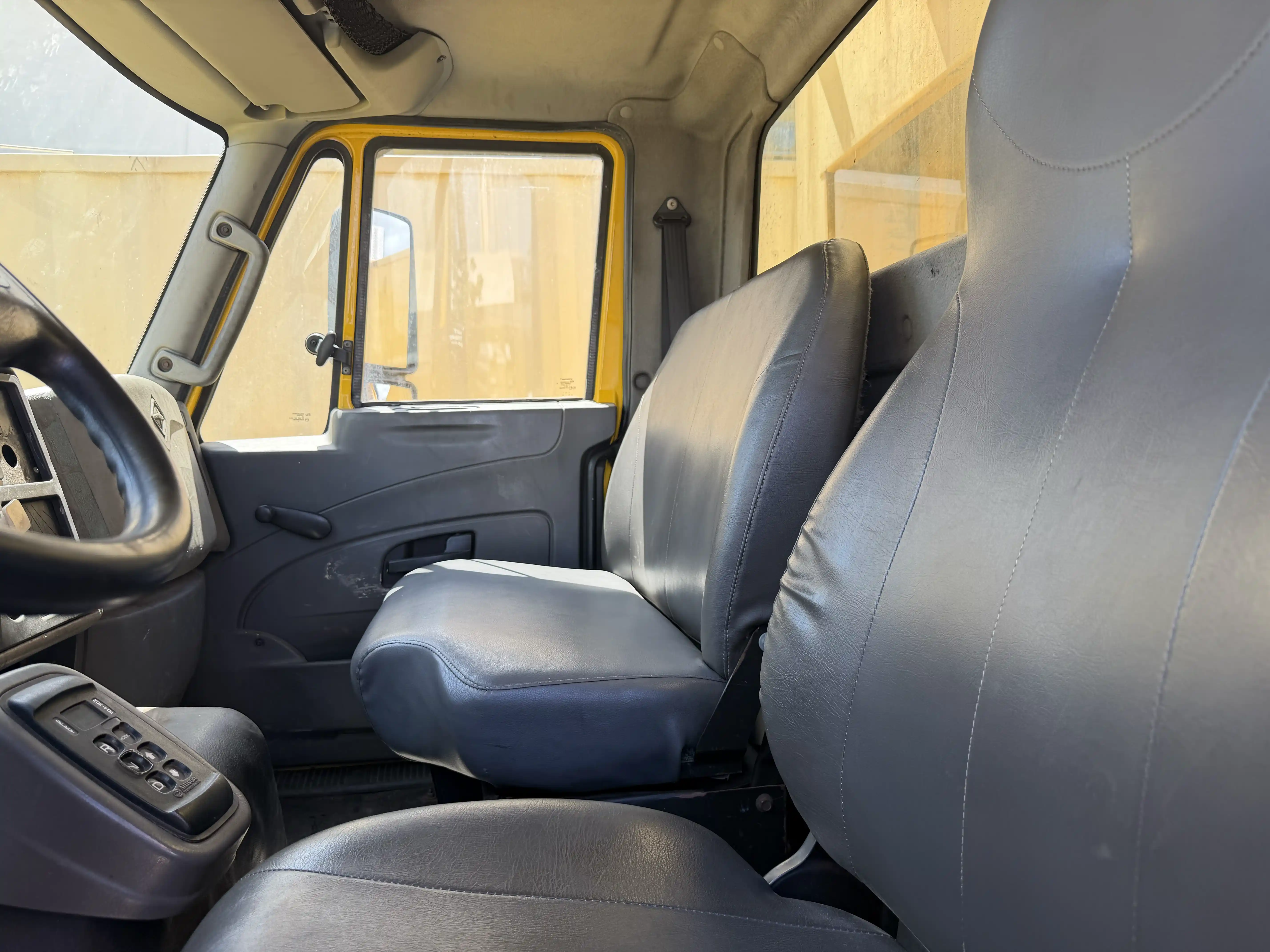 Cab interior with grey vinyl seats and the Allison push-button shift pad