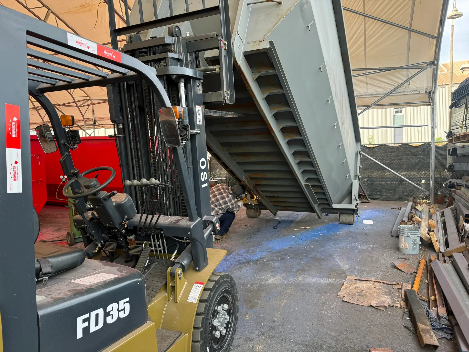 OSI 3.5 ton forklift staging a roll-off dumpster at the HIWASTE MFG yard in Hawaii
