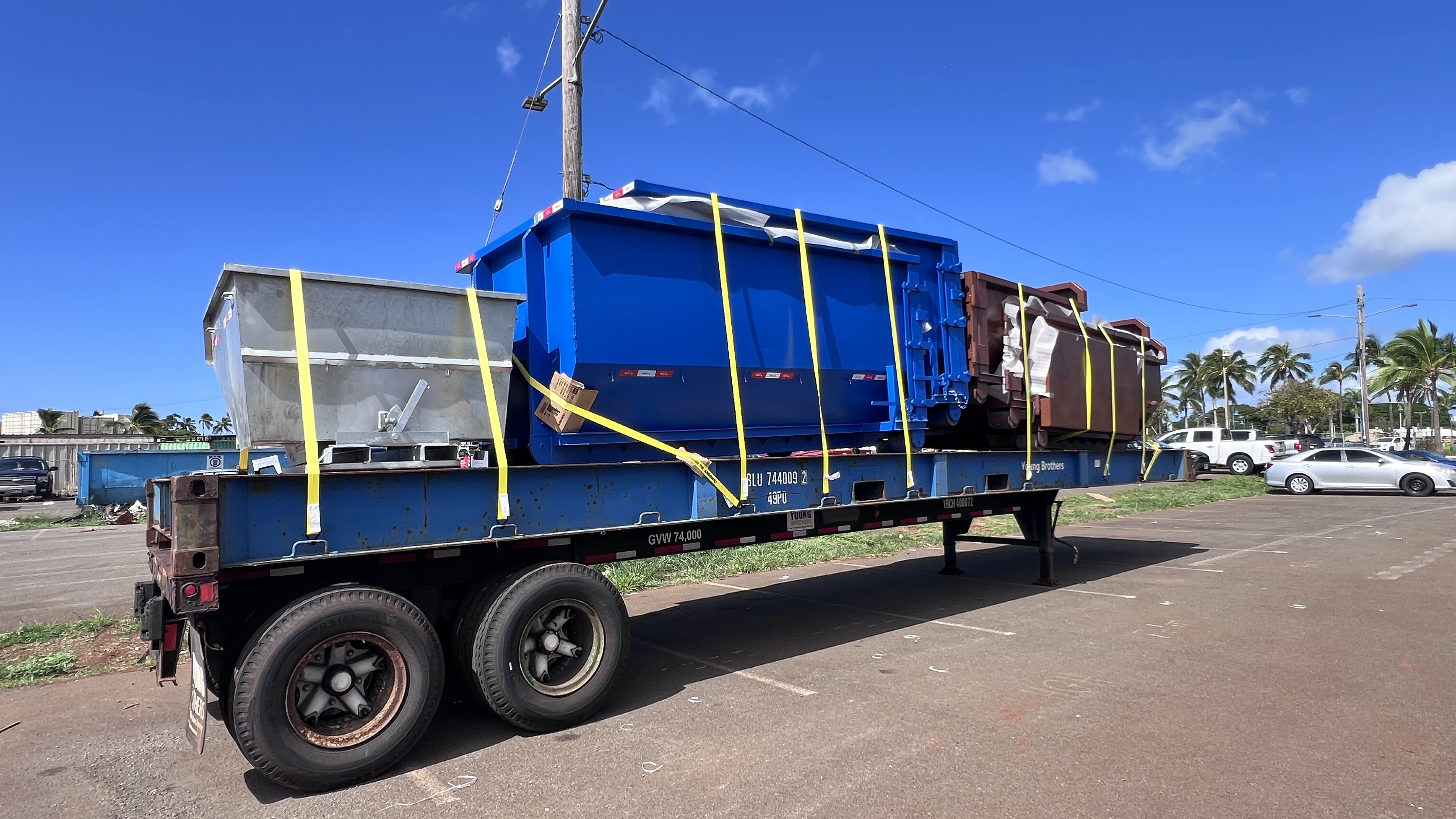 Dumpsters and self-dumping hopper staged on the shipping platform