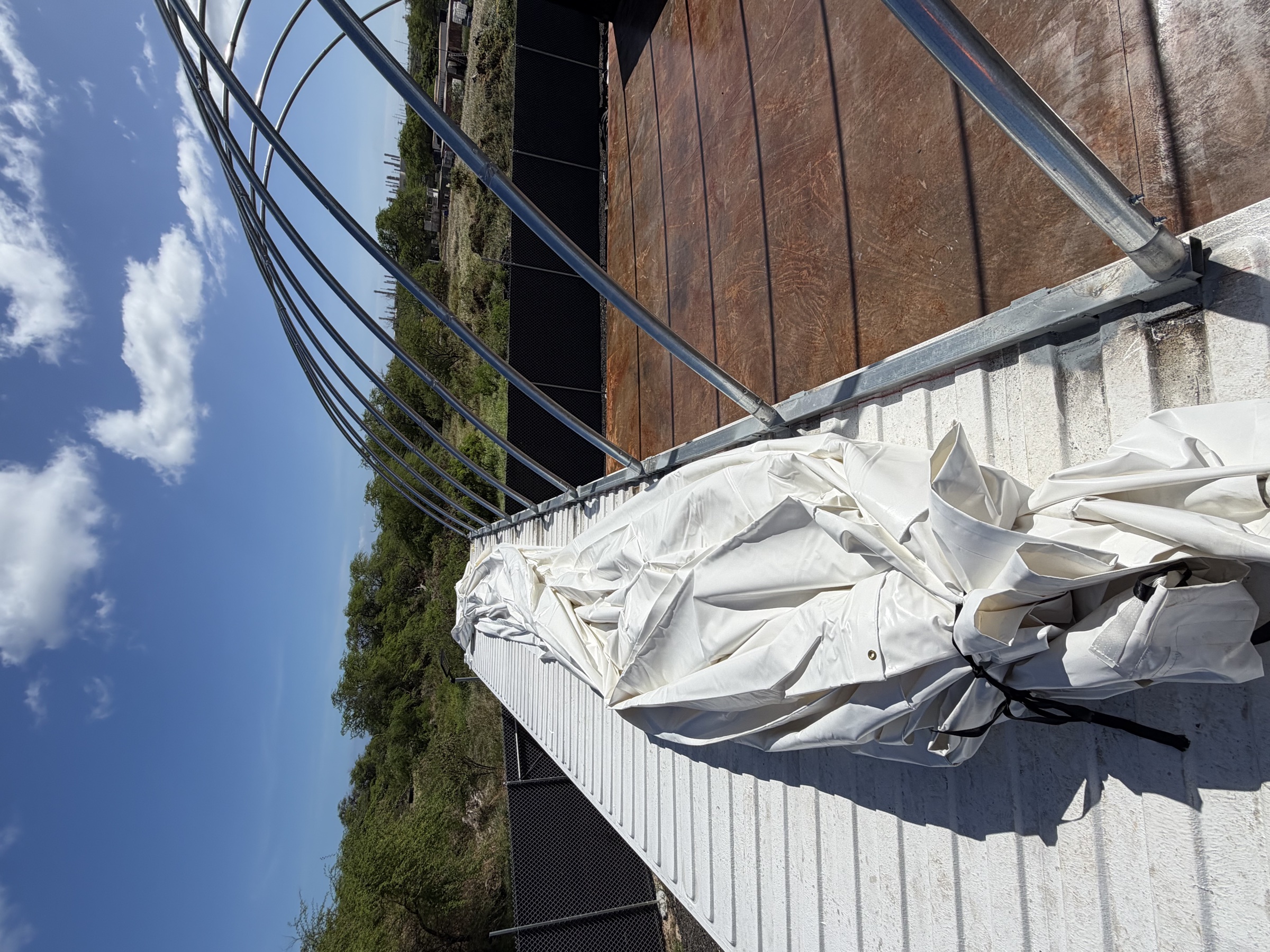 Container tent arches up, tarp cover staged and ready for install