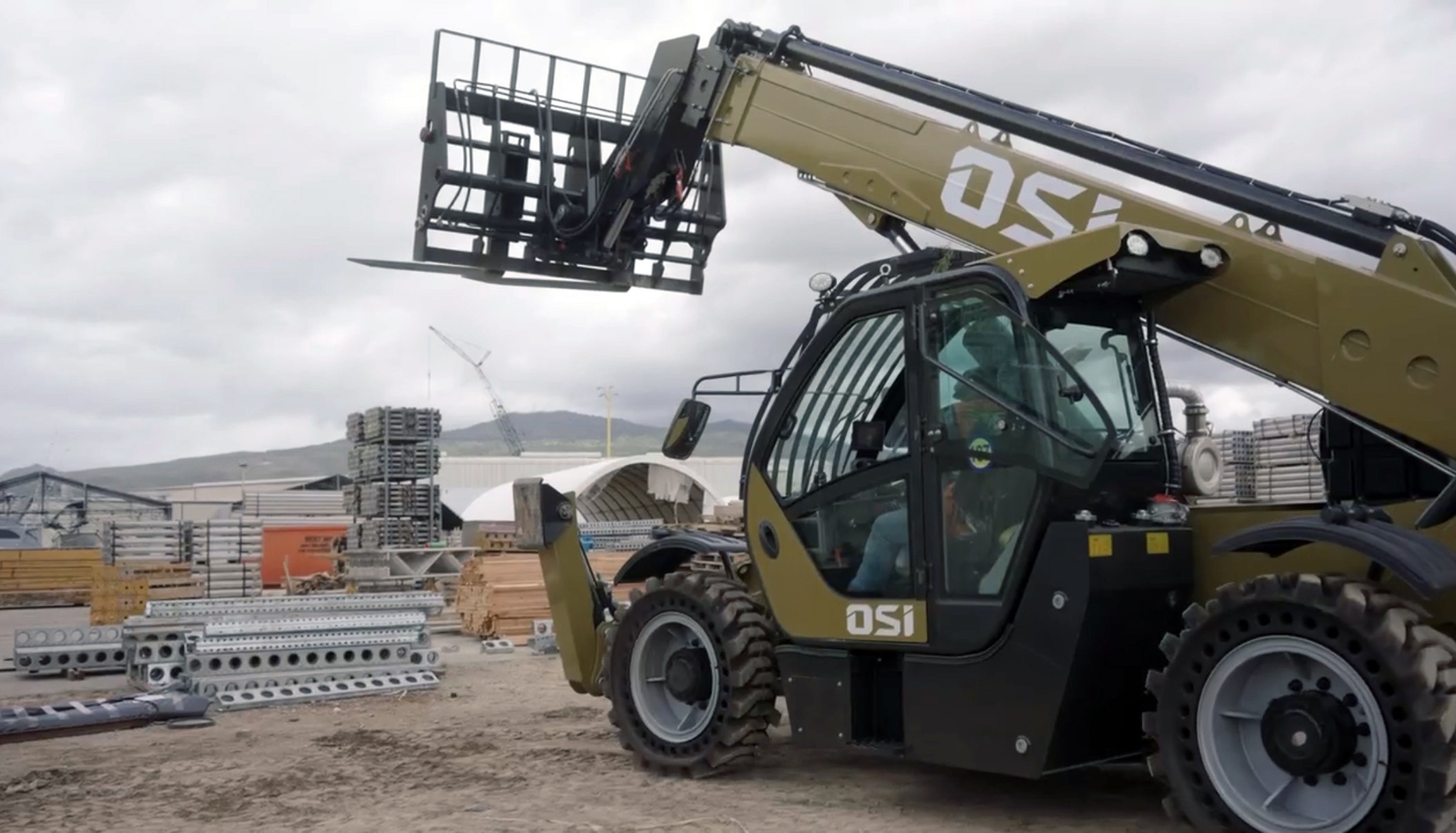 OSI telehandler boom raised with forks, ready to work