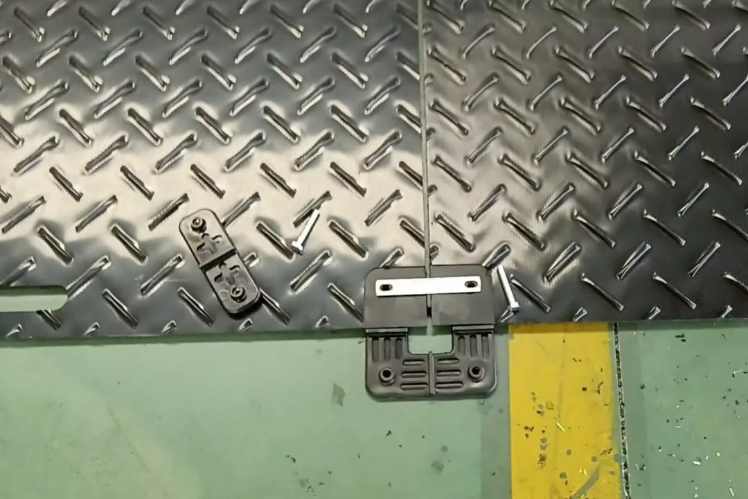 Two HDPE ground mats joined with plastic nut and bolt connectors