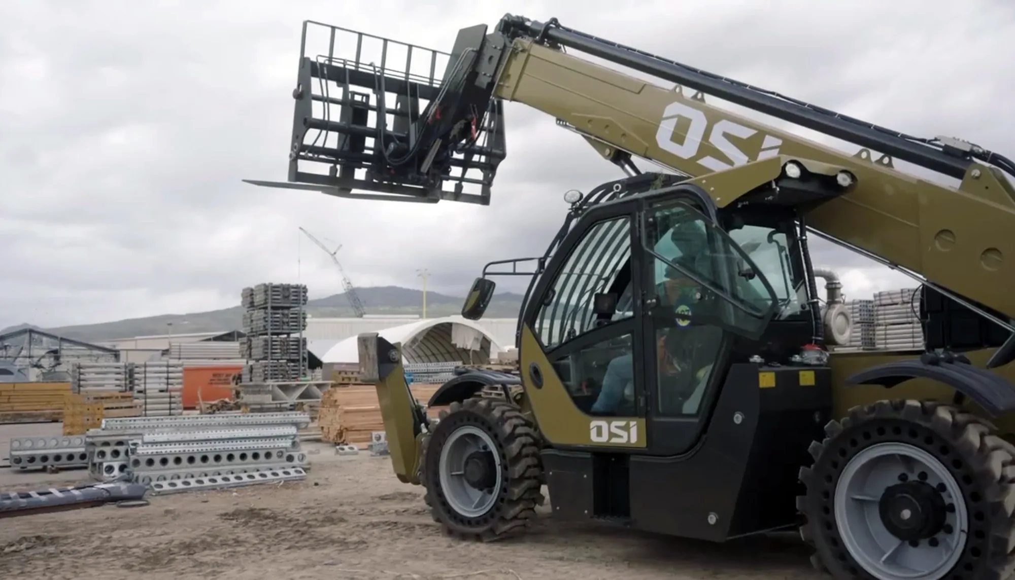 OSI telehandler boom raised with forks, ready to work