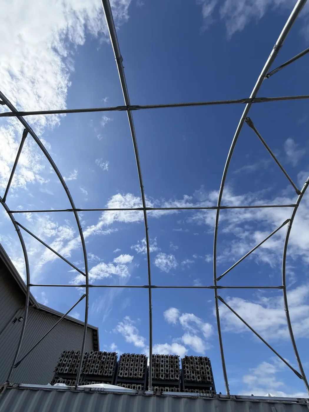 Container tent arches hung with cross pipes and tensioners assembled