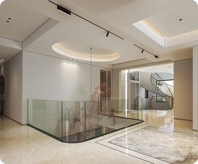 Modern interior hallway with marble flooring, glass railing around a stairwell, and a spiral staircase in the background.
