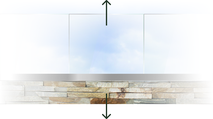 Glass railing with stone base under a cloudy sky background, with upward and downward arrows indicating vertical direction.