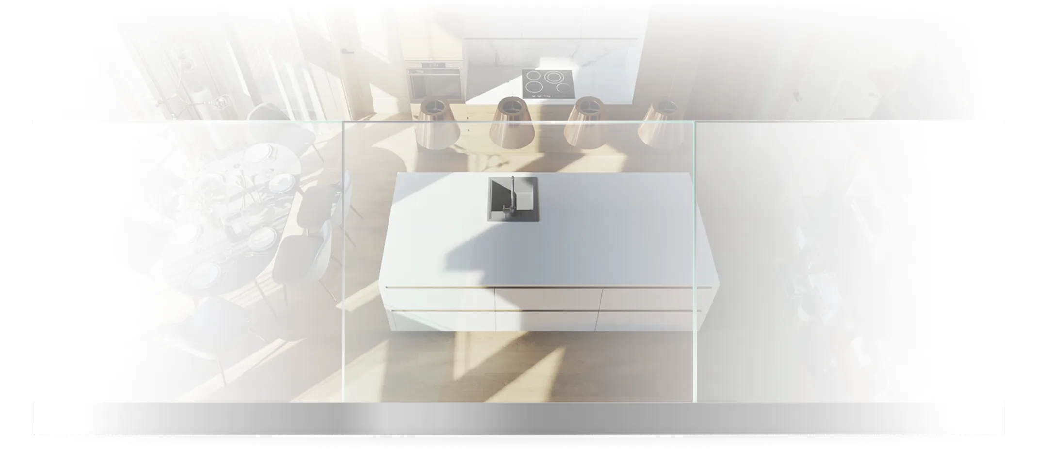 Top-down view of a modern kitchen island with a built-in sink and four pendant lights above it, with a dining table and chairs visible in the background.