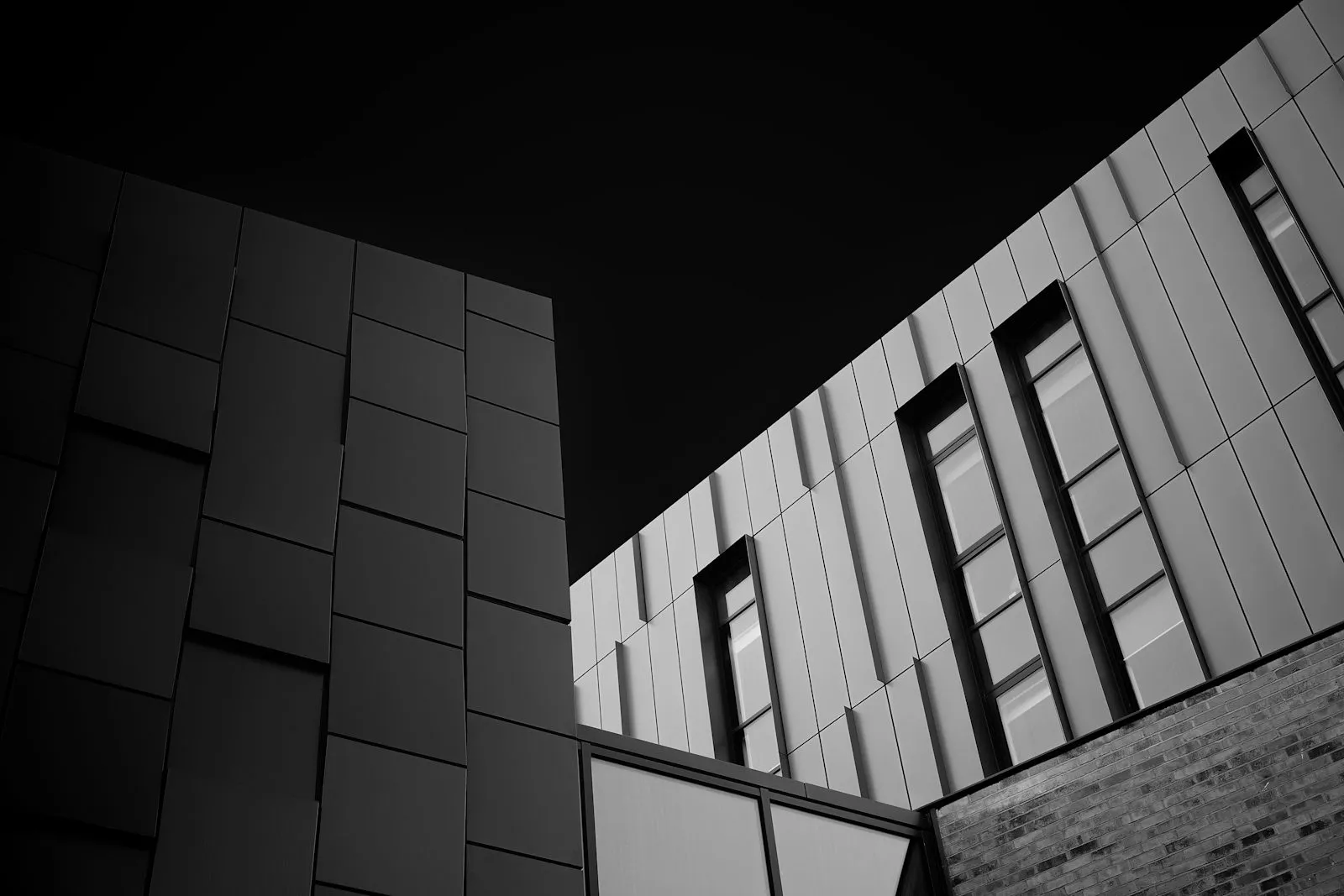 Abstract dark building geometry against a night sky