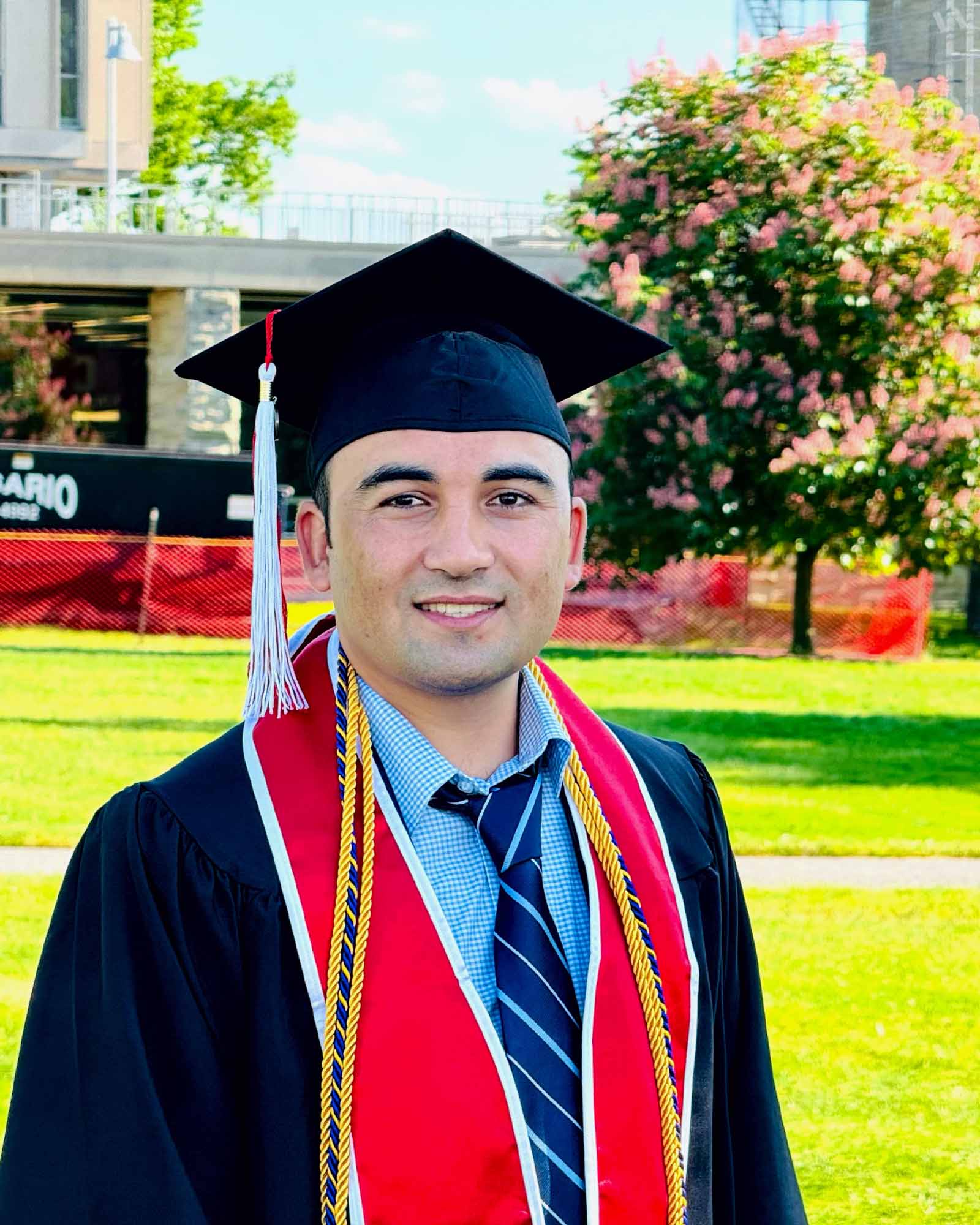 Hassan Ukasha in cap and gown at his Cornell University commencement, Ithaca, New York