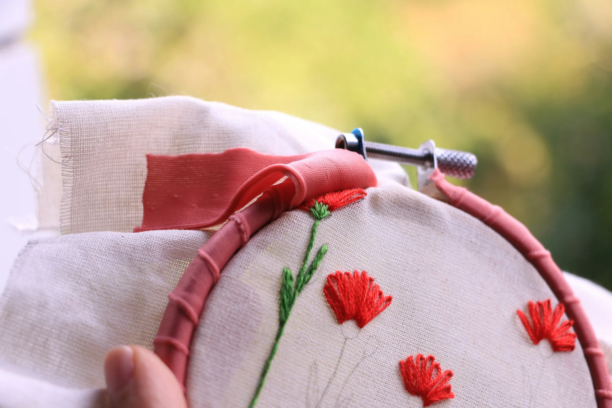 Hand embroidery in progress on cotton cloth