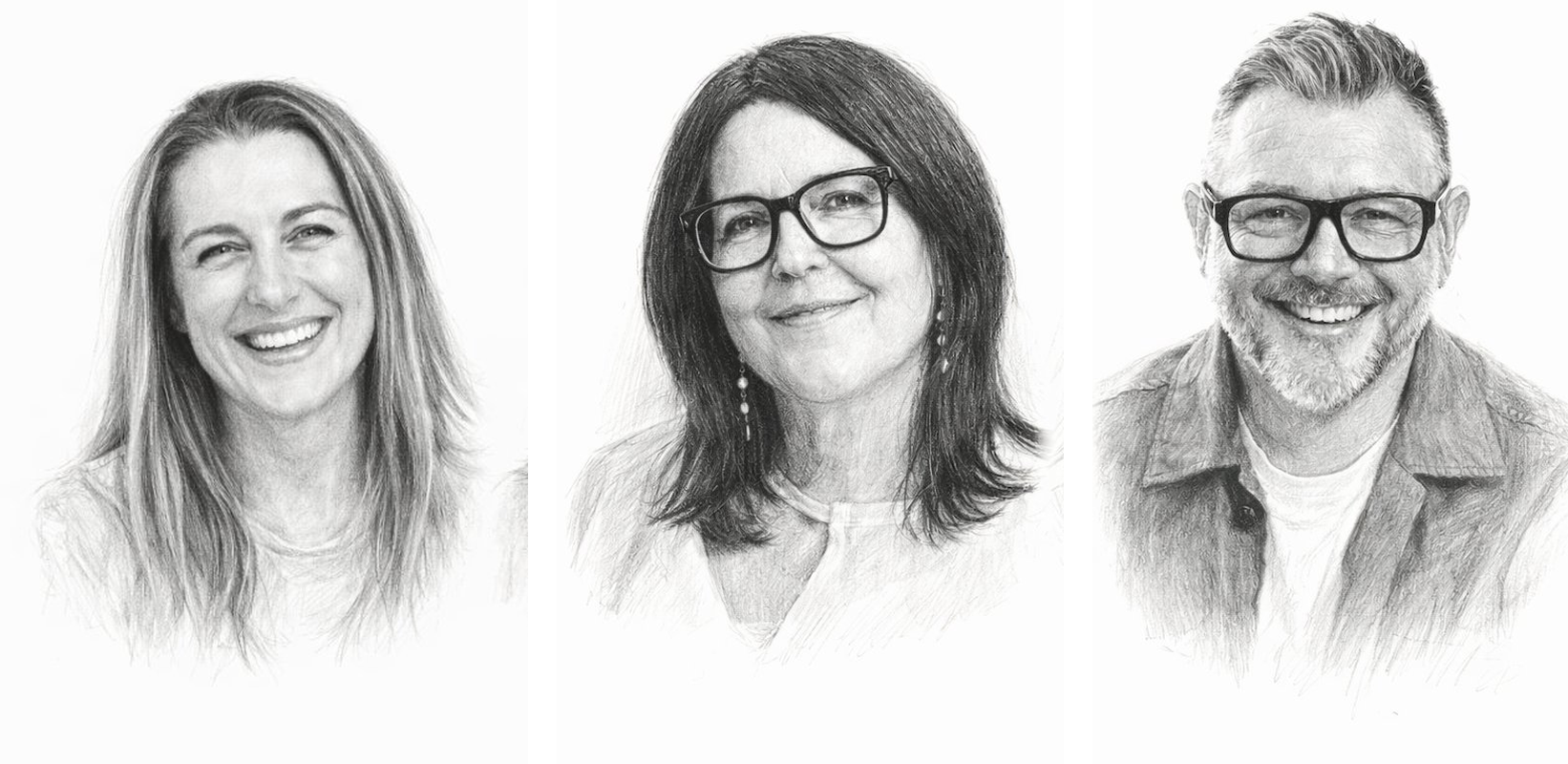 A woman and a man wearing glasses smiling indoors, with the woman sitting on a couch and the man leaning against a wall.